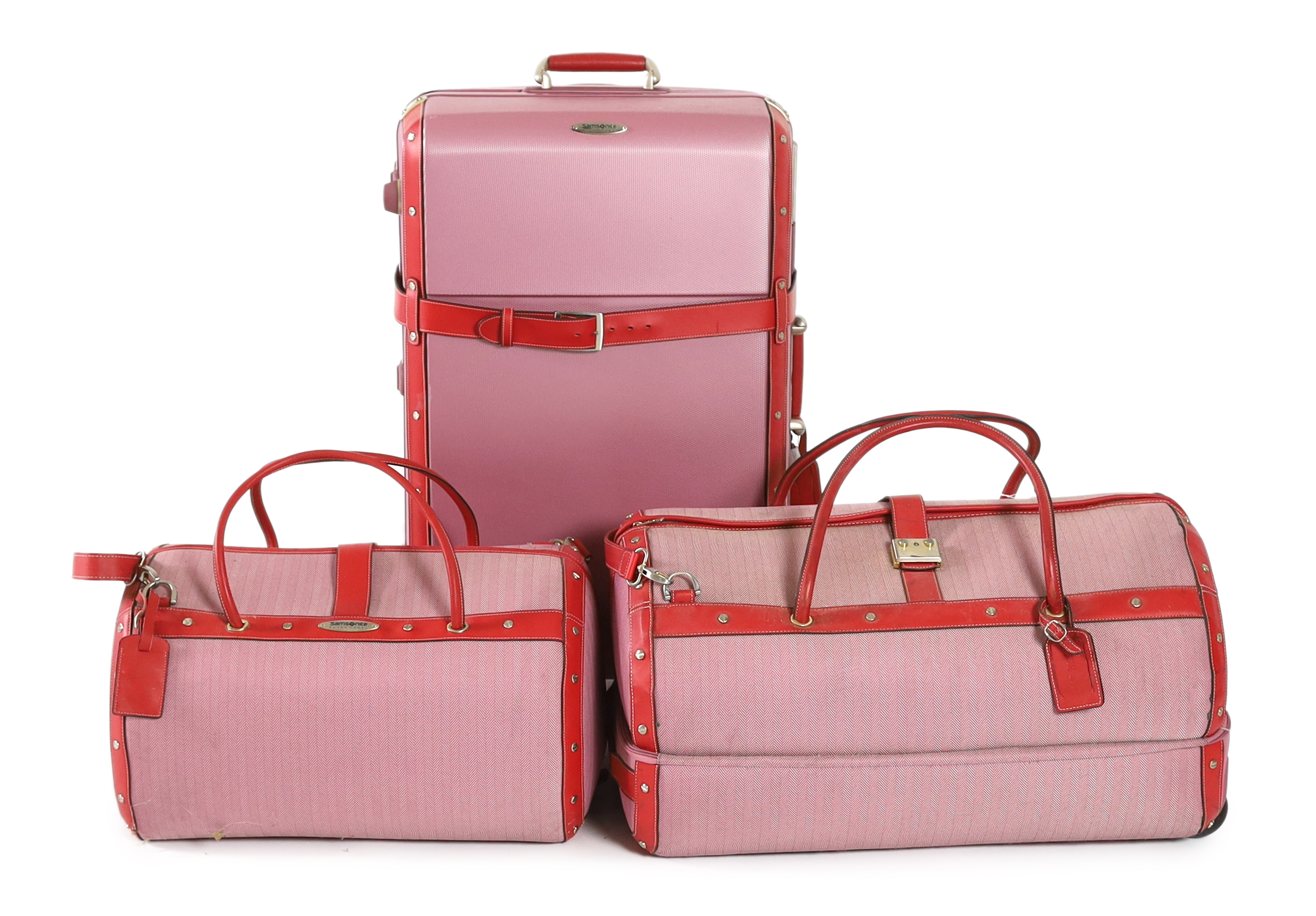 Three pink Samsonite Black Label luggage bags, Hard suitcase height 76cm, width 47cm, depth 31cm, Large holdall height 66cm x 39cm x 36cm, Smaller holdall height 51cm x 30cm x 36cm
